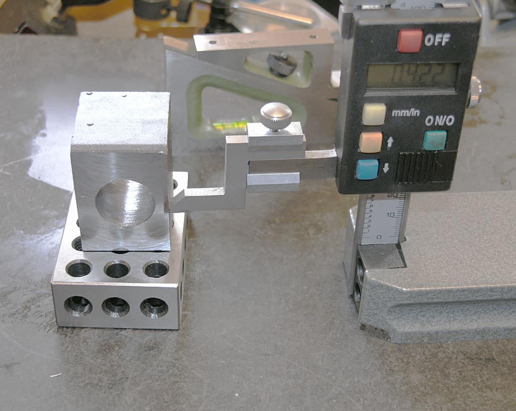 Precision caliper measuring small cylindrical objects.