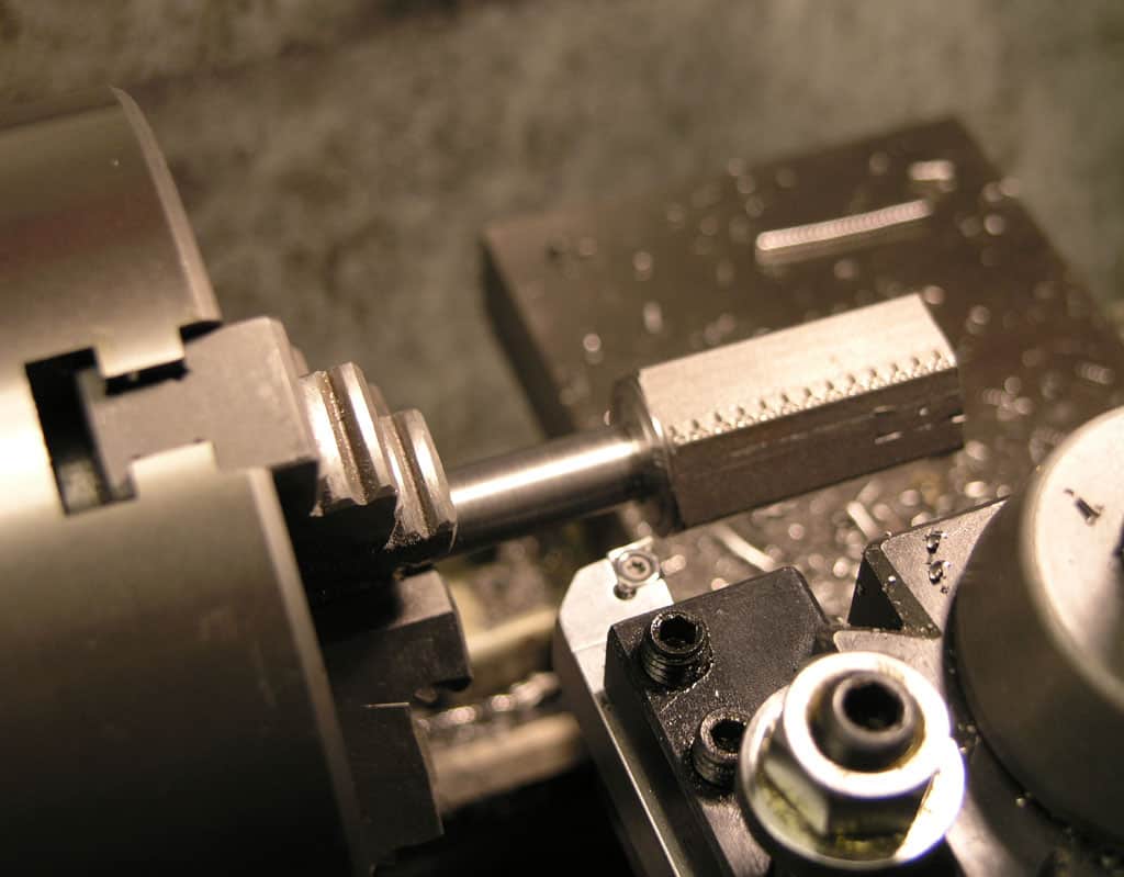 Close-up view of a metalworking lathe or milling machine, emphasizing intricate details and sharp focus.