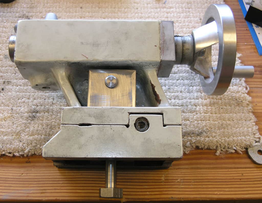Metal vise on a wooden workbench.