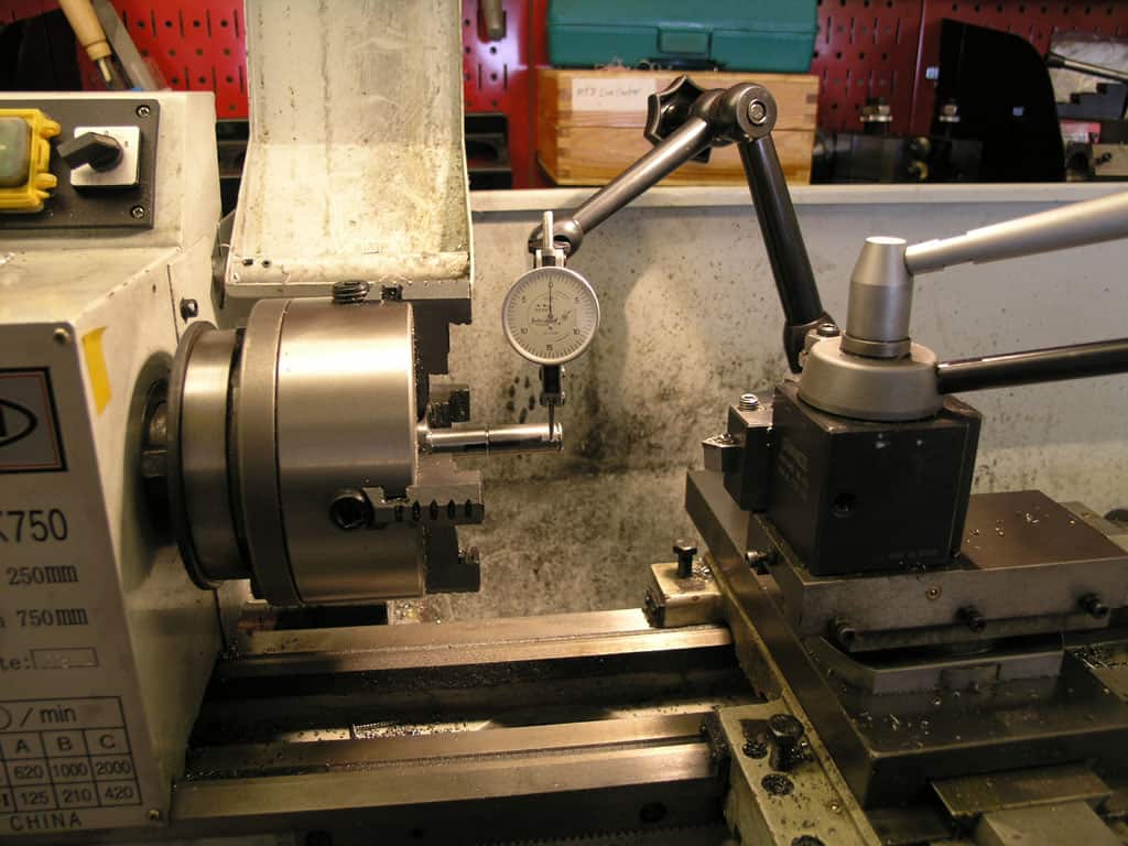 Lathe with rotating spindle, chuck, and precision tools.