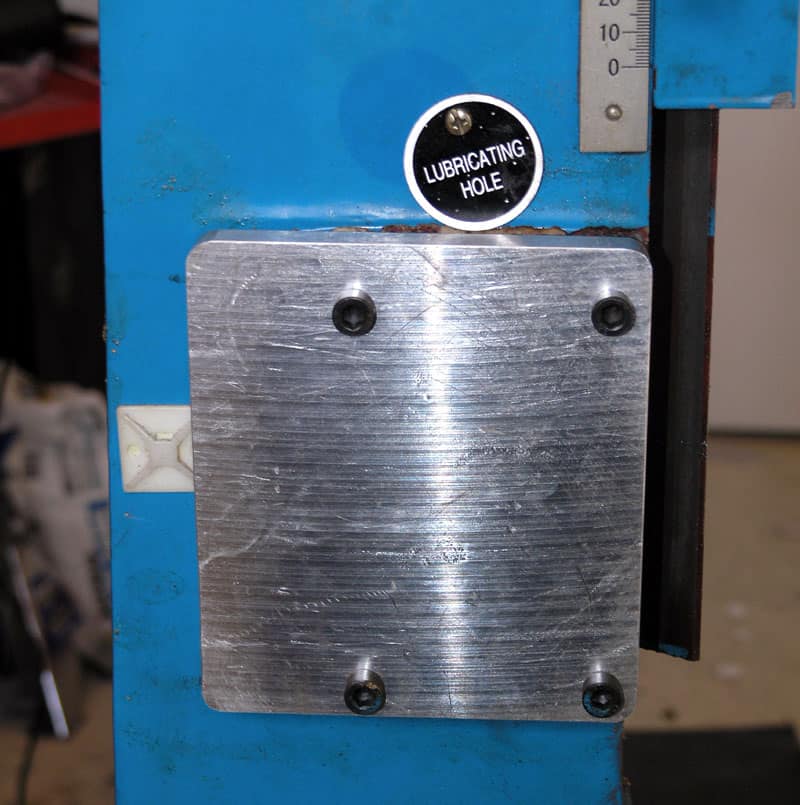 Blue metal panel with aluminum plate and black dial.