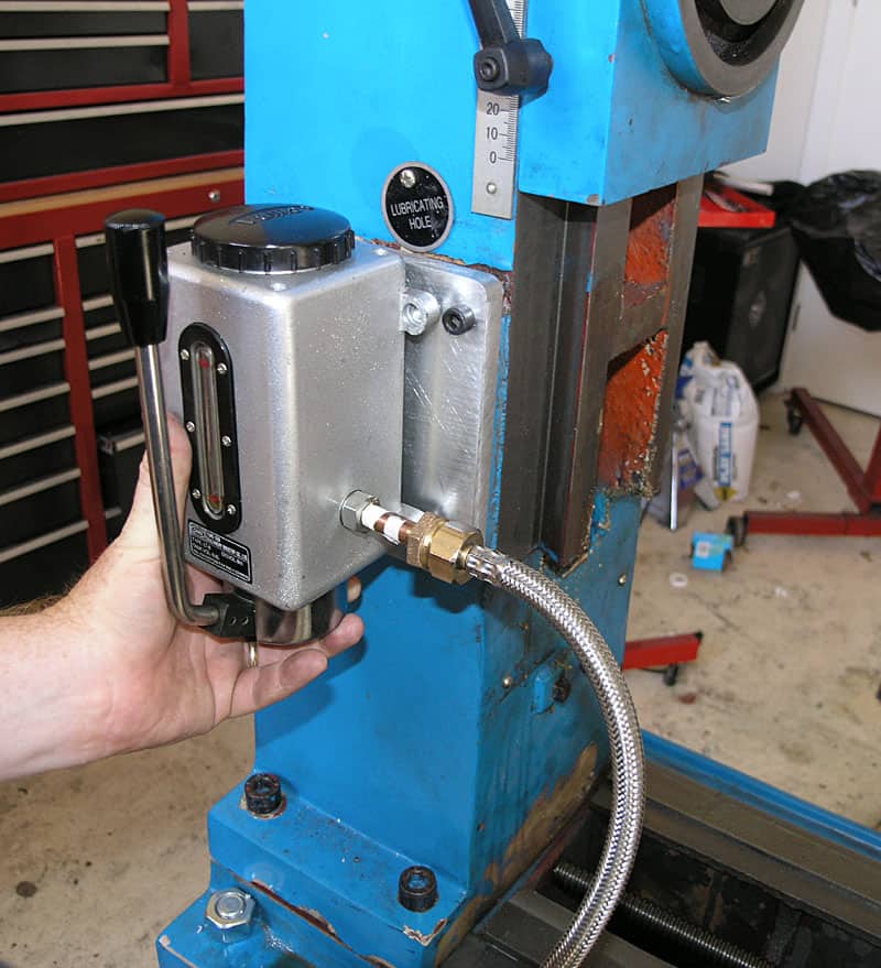 Hand-operated drill press spindle lubrication system with oil delivery to drill bits and cutting tools.