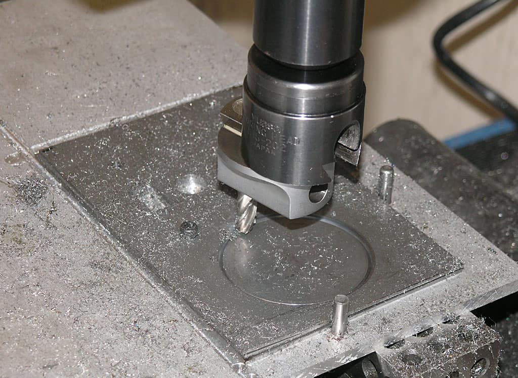 Metalworking tool on CNC machine, with metal shavings.