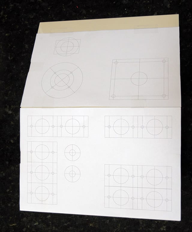 Technical drawings on white paper with geometric shapes and symbols.