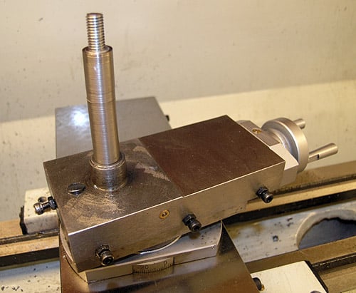 Metalworking tool with vertical shaft and flat base.