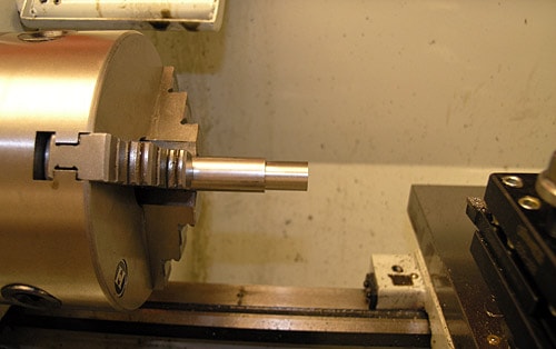 Lathe tool holder on machine bed.