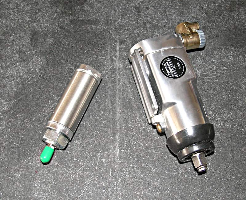 Two cylindrical metal components with distinct features against a dark gray background.