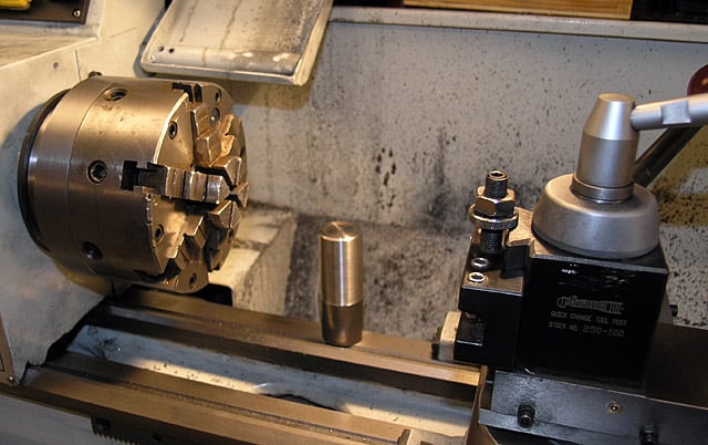 A lathe toolholder with chuck and collet set up for turning operations.