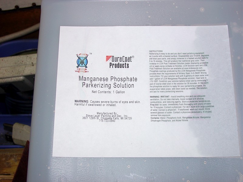 DuraCoat Products logo on chemical solution container with warning labels.