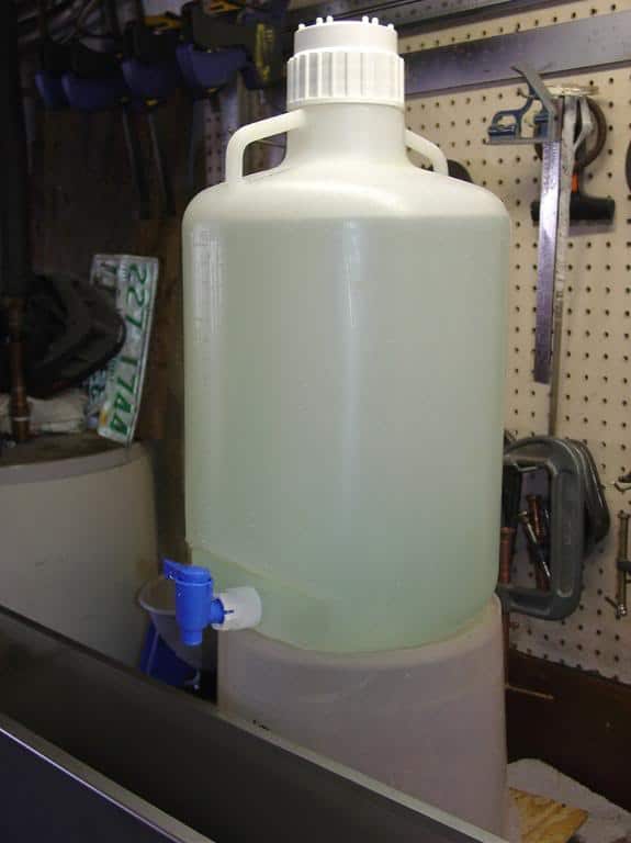 Large white plastic container with handle and spigot.