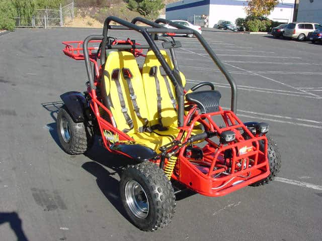 A red and yellow off-road vehicle with a yellow seat and rugged tires.