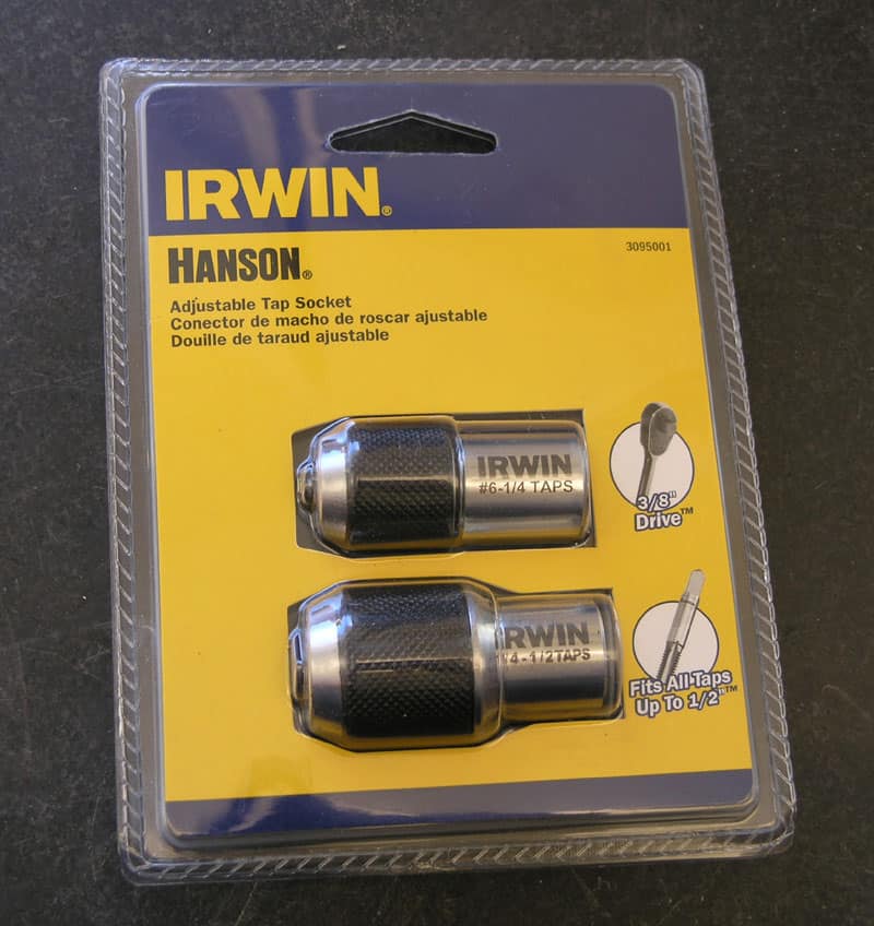 Plastic package containing Irwin Hanson adjustable tap adapters.