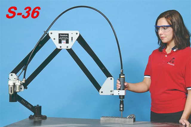 Woman in safety glasses using Plekker tapping arm with flexible rod attachment.