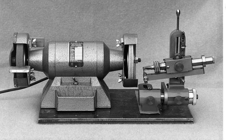 Industrial tool with cylindrical body and two rotating wheels on either side.