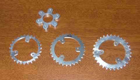 Three silver sprockets with five teeth each.