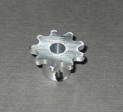 Silver metal sprocket with threaded center hole on flat surface.