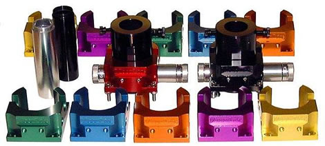 Anodized aluminum parts in various colors arranged on a white background.