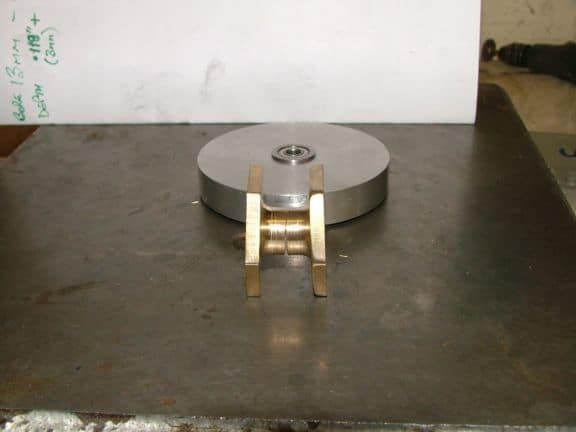 Metal object with two cylindrical components attached.