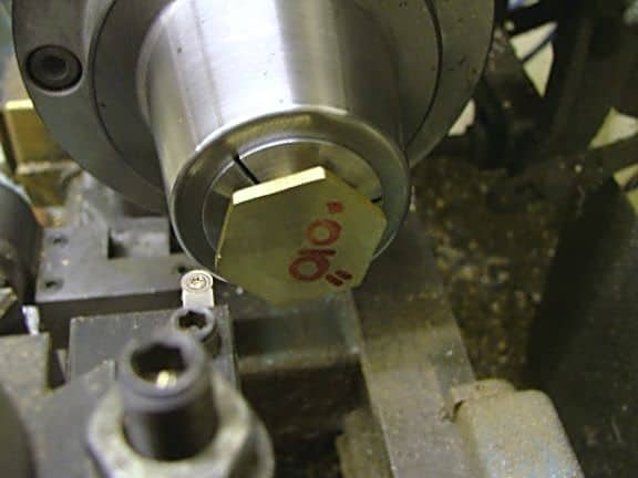 Metal object with red bear logo and stylized text.