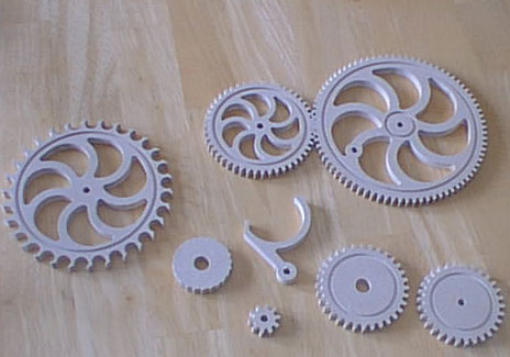 White clock gears on light-colored wood.