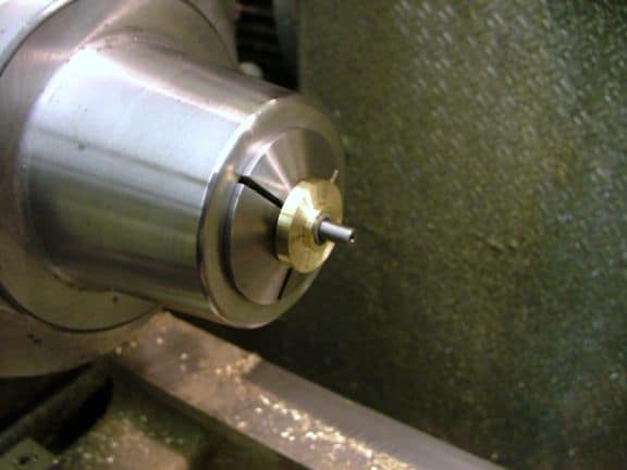 Metal component with brass pin.