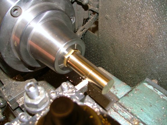 Close-up view of a metal workpiece being machined on a lathe.