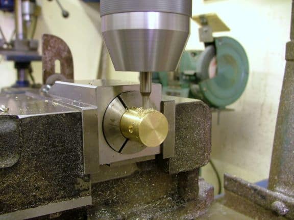 Metalworking tool with brass component attached to silver cylindrical body.