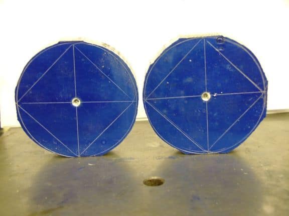 Two blue circular objects with white lines and central holes.