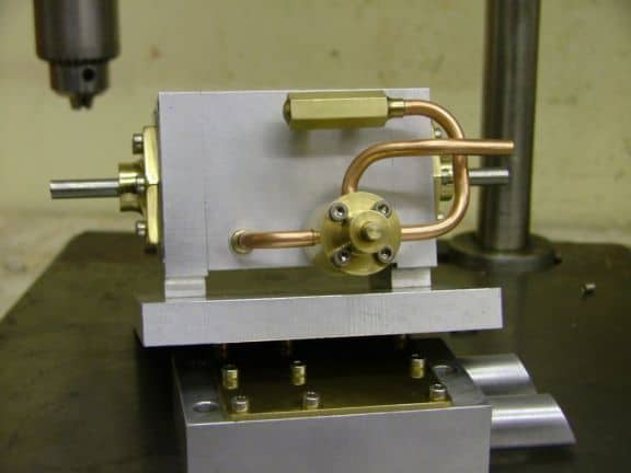 Metal component with brass tubing attached to an aluminum base plate