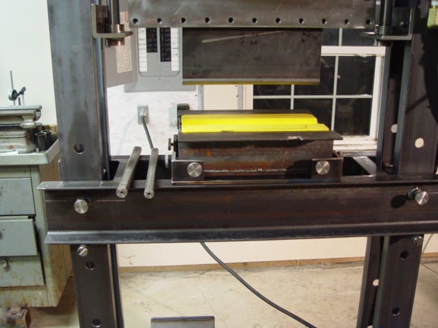 Industrial press brake with steel frame, hydraulic system, and adjustable vise.