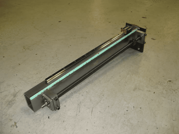 Metal bar with light blue stripe on scratched concrete floor.