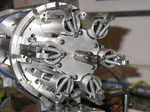 Metal components with multiple spring-loaded triggers.