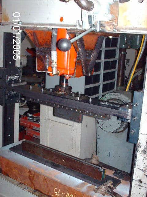 Industrial press brake with mechanical components.