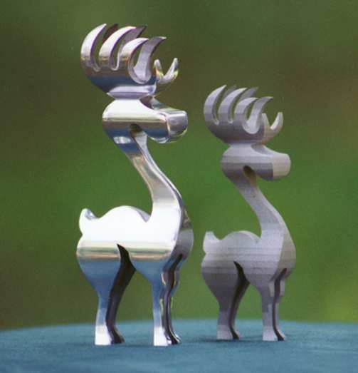 Intricately cut silver reindeer figurines.