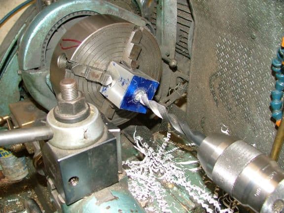 Metal tool or cutting bit, cylindrical shape, flat end, rough metal surface.