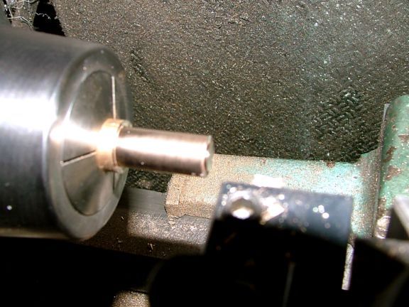 Metal shaft protruding from cylindrical object, possibly made of steel or aluminum.