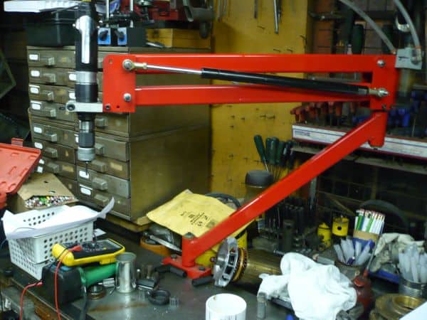 Red tapping head in cluttered workshop or garage.