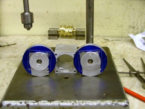 Metalworking setup with blue components and machinery.