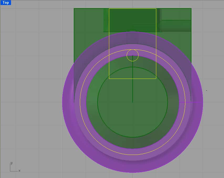 A CAD model of a circular object with concentric circles and purple outer ring.