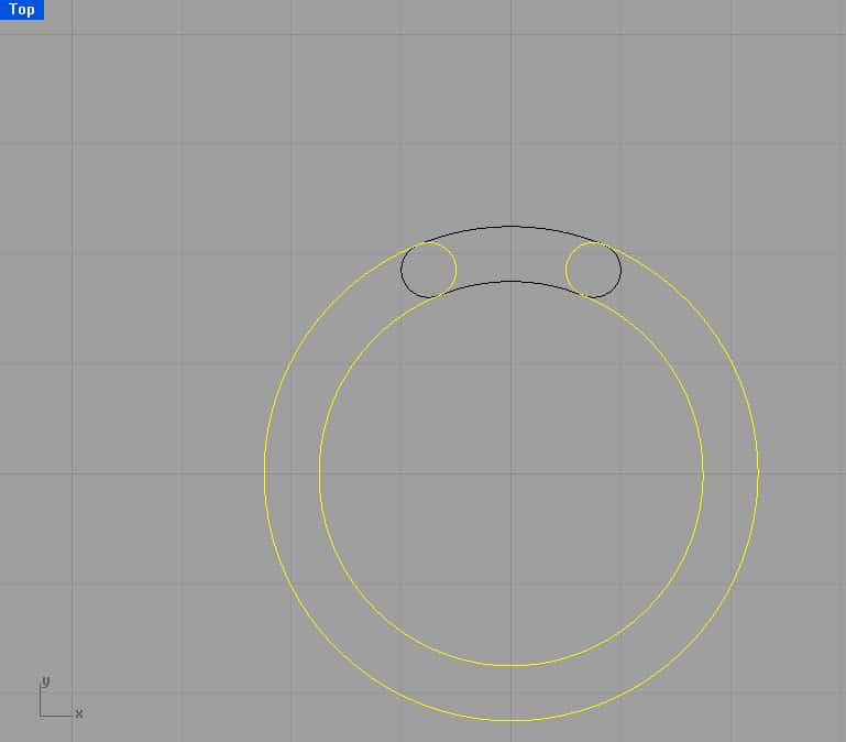 Technical illustration of two concentric circles connected by an arc.