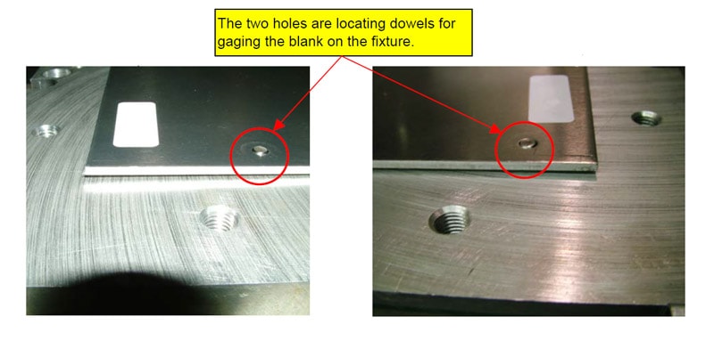 Two metal dowel pins in parallel holes on a metal surface, with a small backing plate.