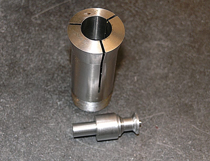 Silver-colored metal component with cylindrical shape and central circular hole.