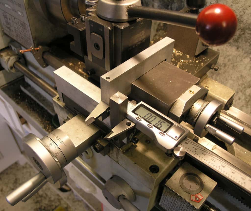 Metalworking lathe and digital calipers.