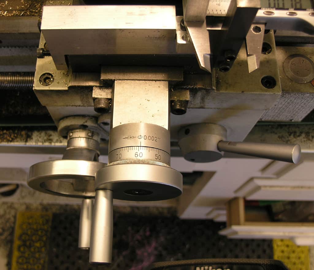 Metalworking machine tool with micrometer dial indicator.