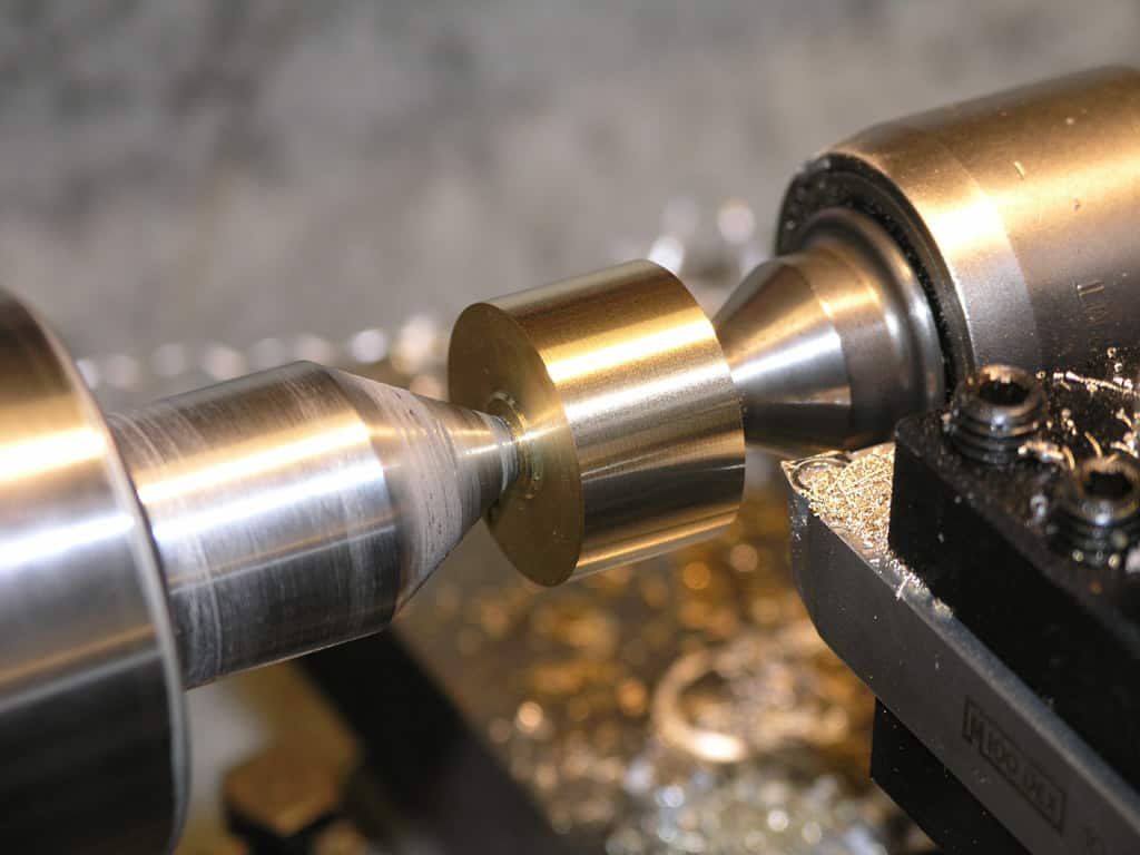 Metal being machined on a lathe with detailed view.
