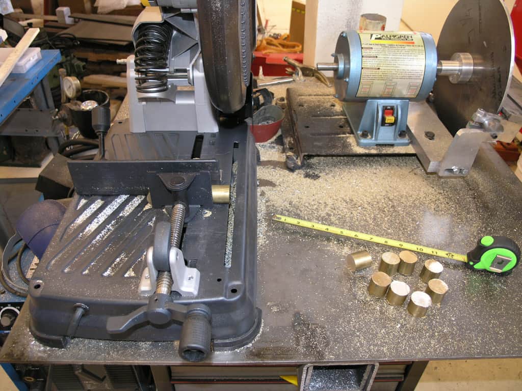 Cluttered machine shop workbench with various tools and equipment.