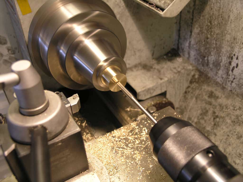 A lathe machine in operation, machining a metal workpiece.