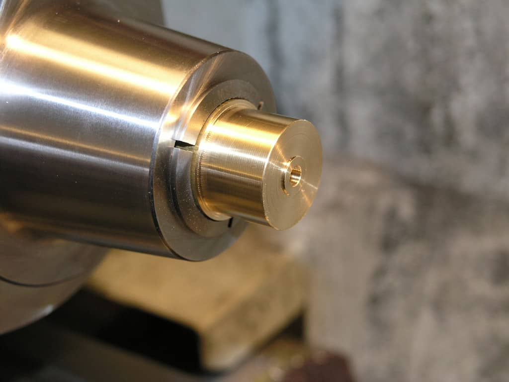 Metal part with brass component, possibly machined.