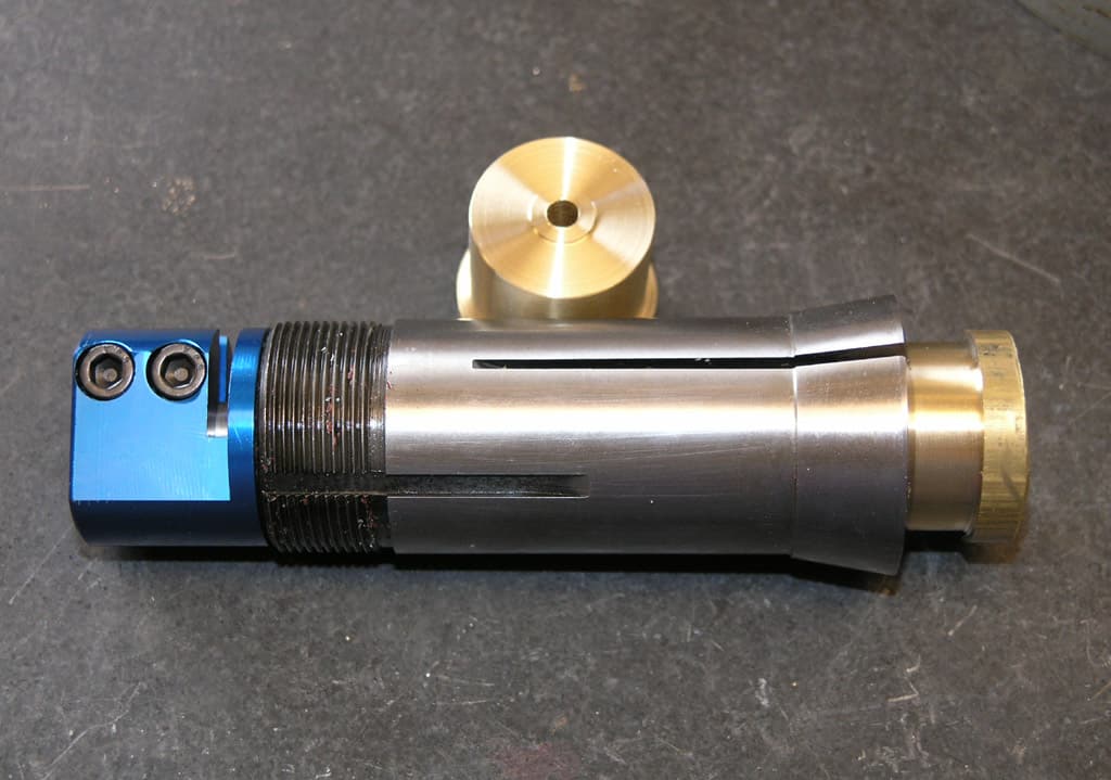 Two cylindrical objects with attached fittings and components made from various materials including metal and plastic.