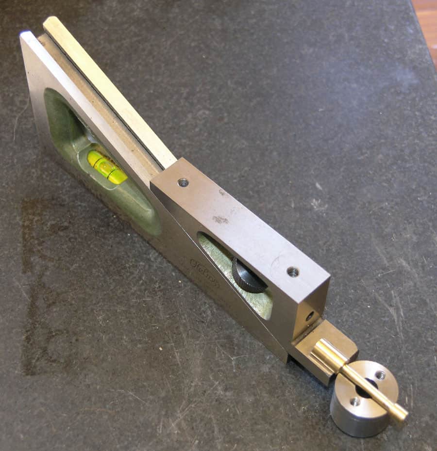 Precision engineering tool with stainless steel body and clear plastic window, measuring angles and alignments.